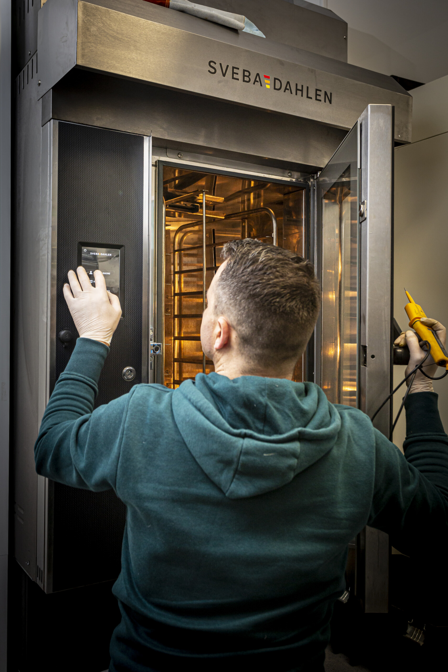 Engineer repairing oven